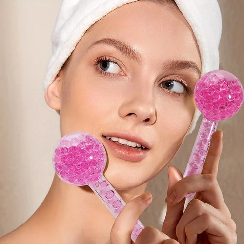 Woman holding pink facial rollers 