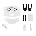 LED facial beauty device with mask, attachments, and power adapter on a white background