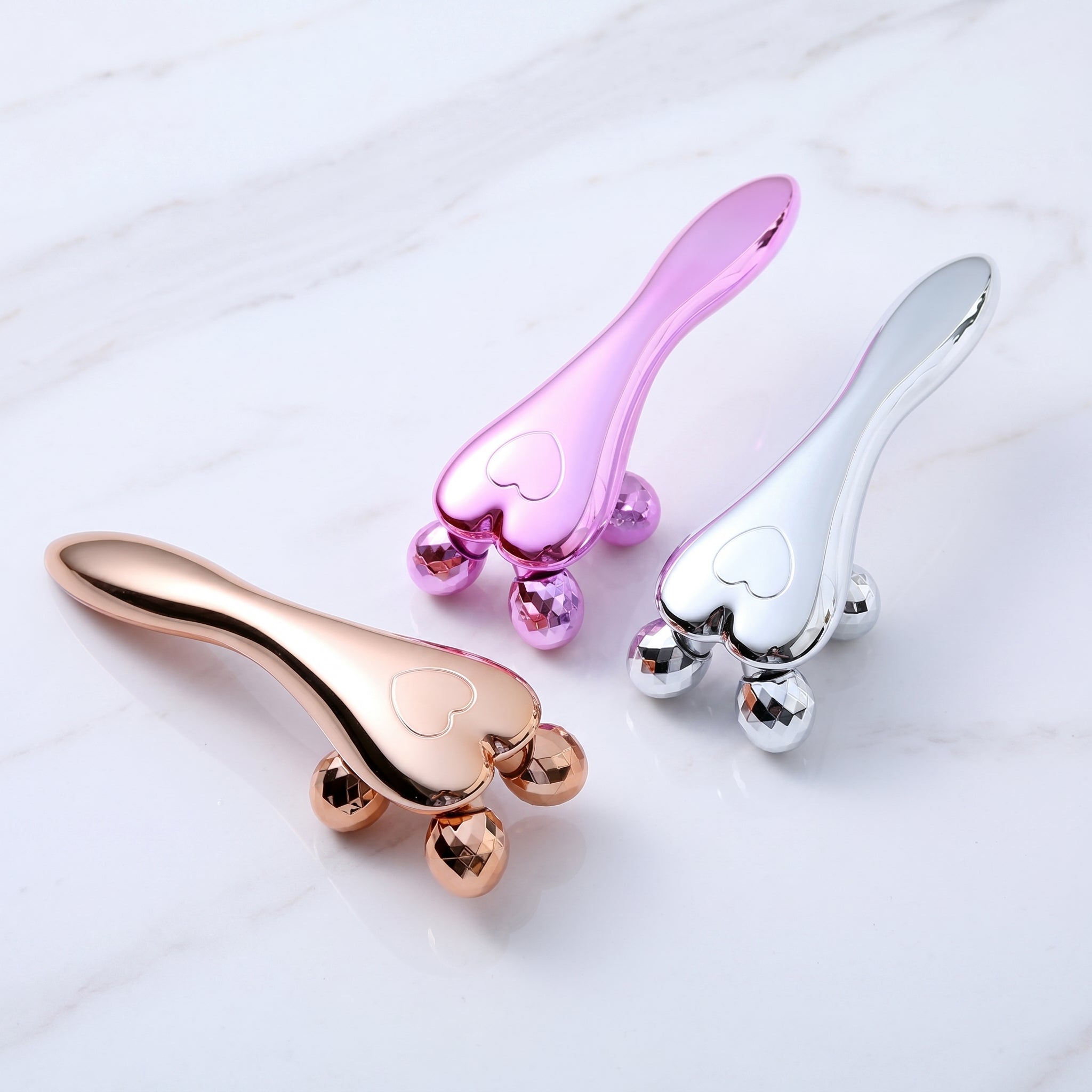 Pink, Gold And Silver V-Line 4D Facial Rollers for jawline slimming and lifting.